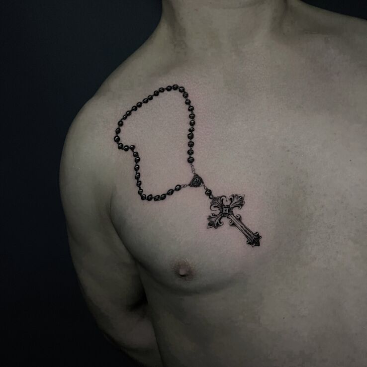 Tattoo Rosary with cross in black and gray motif and realistic style on the chest