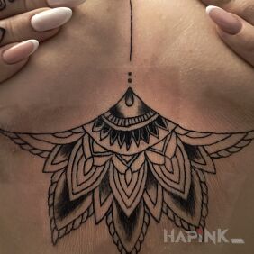 Tattoo Mandala between the breasts motif: black and gray style: graphic / illustrative