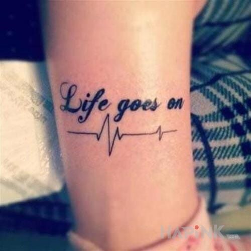 Tattoo Life goes on in lettering motif on the leg