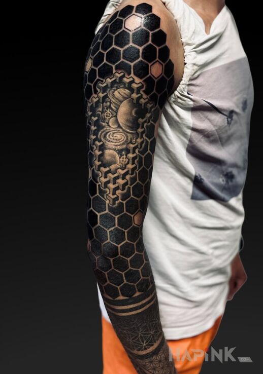 Tattoo Geometry in cosmos motif and blackwork / blackout style On the arm