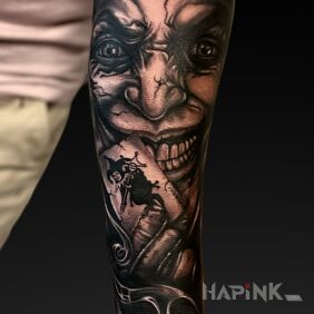 Tattoo Joker with a card On the arm motif: black and gray style: realistic