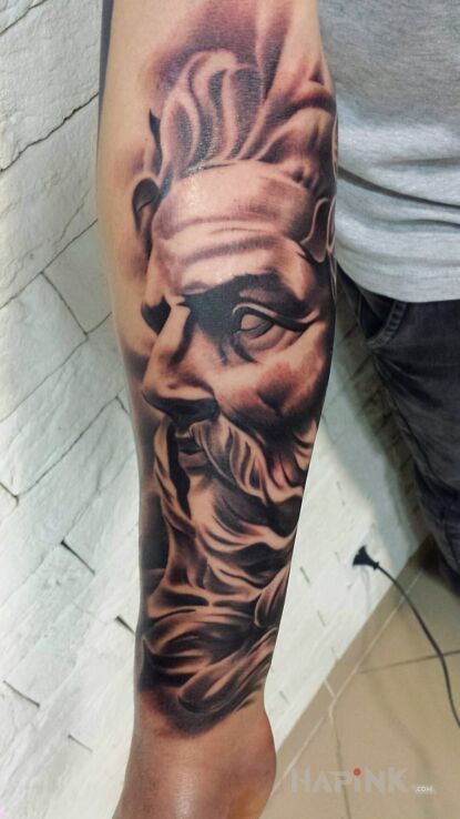 Tattoo Posejdon in realistic style on the forearm