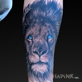 Tattoo Lion with blue eyes On the arm motif: zodiac signs style: realistic