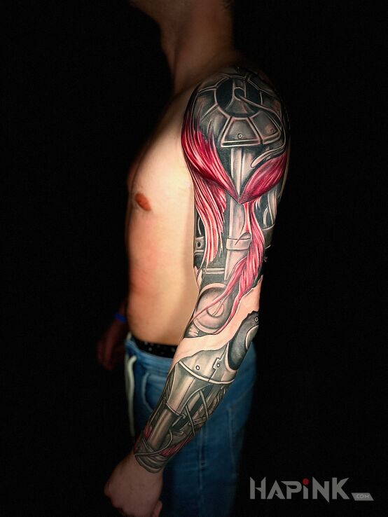 Tattoo Biomechanics full sleeve in colorful motif and biomechanics style on the forearm