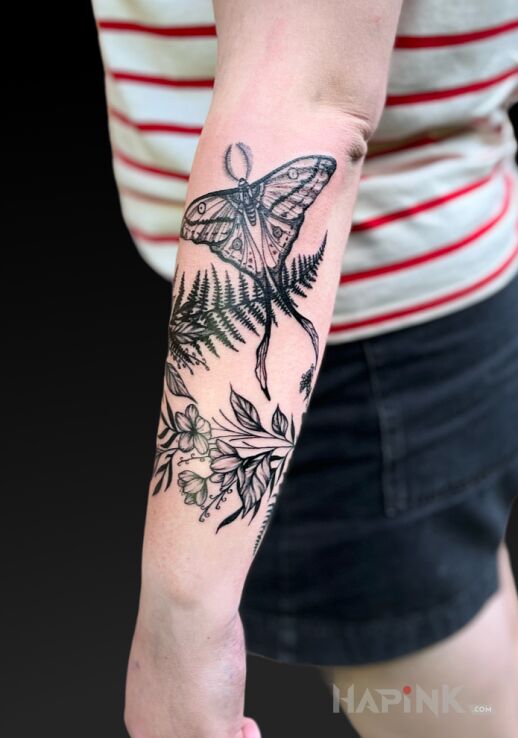 Tattoo Floristry in black and gray motif and realistic style On the arm