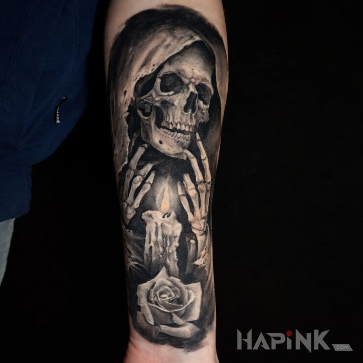 Tattoo Grim Reaper over a burning candle in objects motif and realistic style on the forearm