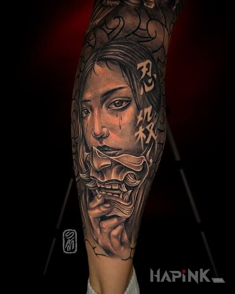 Tattoo Geisha in faces motif and realistic style on the calf