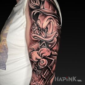 Tattoo Scrooge with hands on the safe On the arm motif: black and gray style: cartoon / comic book