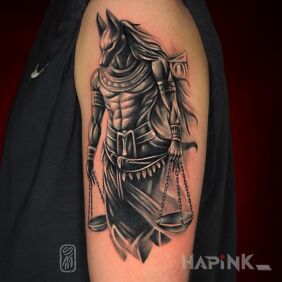 Tattoo Anubis on the upper arm motif: black and gray style: realistic