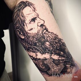 Tattoo Thor on the bicep motif: faces style: graphic / illustrative