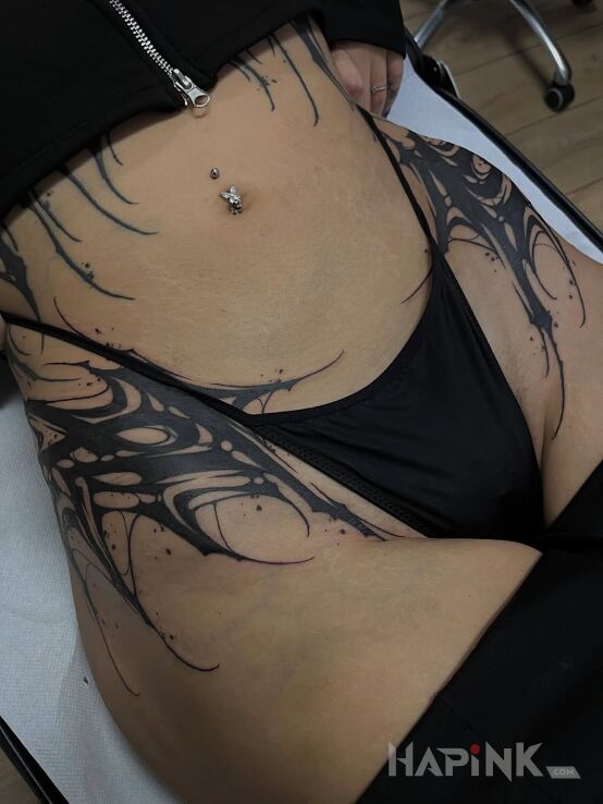 Tattoo Black hips in other motif and blackwork / blackout style on the hip