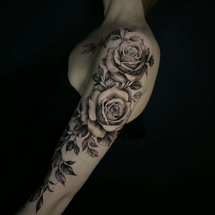 Tattoo Black and gray shaded roses in 3D motif and realistic style On the arm