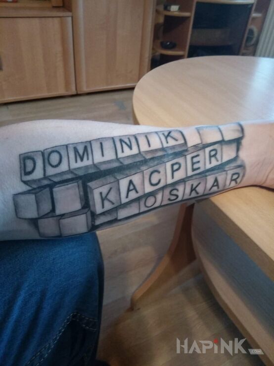 Tattoo Moje dzieciaki in lettering motif on the forearm