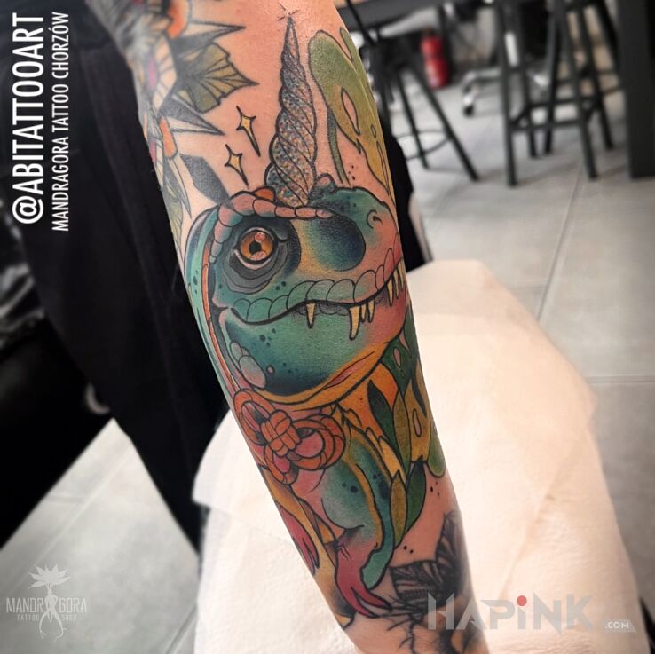Tattoo T-rex unicorn in animals motif and neo-traditional style on the forearm