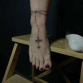 Tattoo Delicate Rosary near the ankle motif: black and gray style: realistic