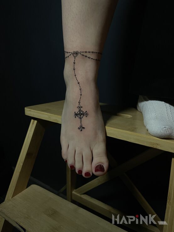Tattoo Delicate Rosary in objects motif and realistic style on the foot