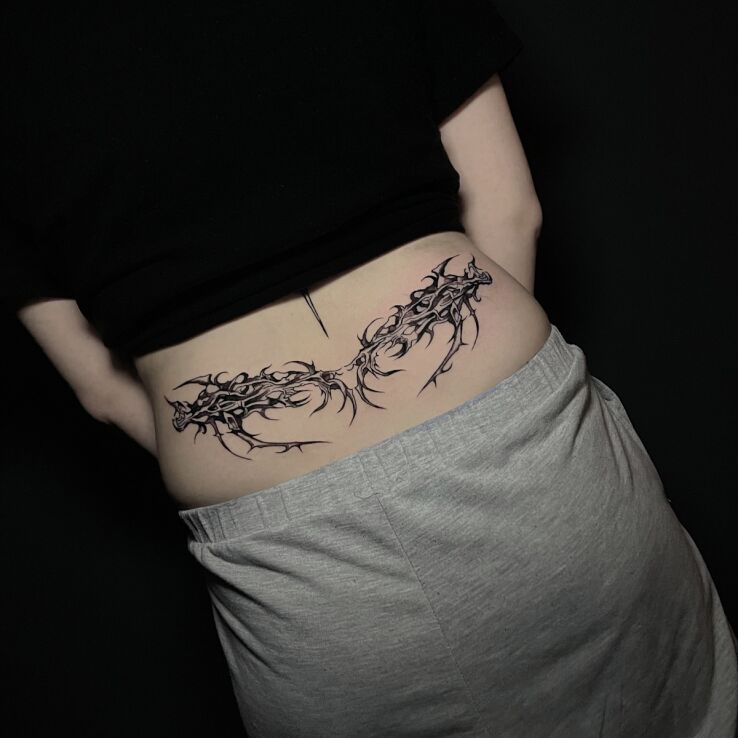 Tattoo Neotribal on the lower back in black and gray motif on the back