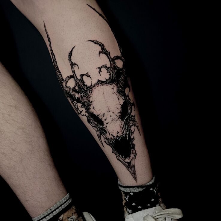 Tattoo Goat skull in dark motif and graphic / illustrative style on the tibia