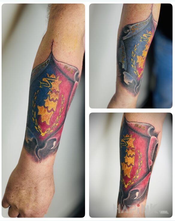 Tattoo Pogoń Szczecin Crest in ripped skin motif and graphic / illustrative style On the arm