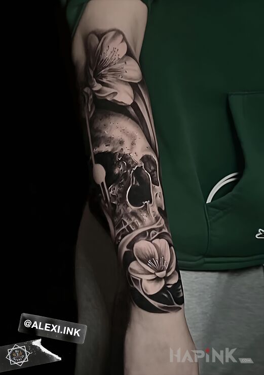 Tattoo Skull with flowers in flowers motif and realistic style On the arm