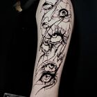 Dark abstraction eyes on the arm