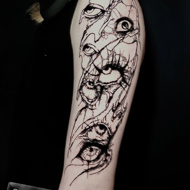 Tattoo Dark abstraction eyes on the arm in dark motif and sketch style on the forearm