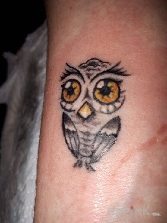 Tattoo Sowa in animals motif on the forearm
