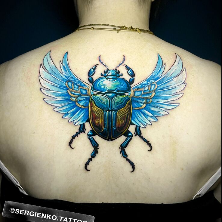 Tattoo Colorful Scarab in insects motif and realistic style on the back