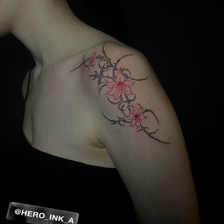 Tattoo Cybersigilism with red flowers in colorful motif on the upper arm