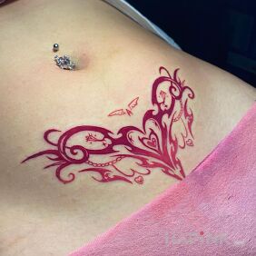 Tattoo Pink tribal heart on the stomach motif: colorful