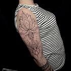 Feminine tattoo with lotus flowers