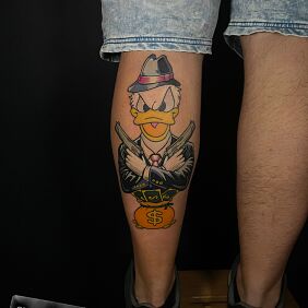 Tattoo Donald Duck with guns and a bag of money on the calf motif: characters style: cartoon / comic book