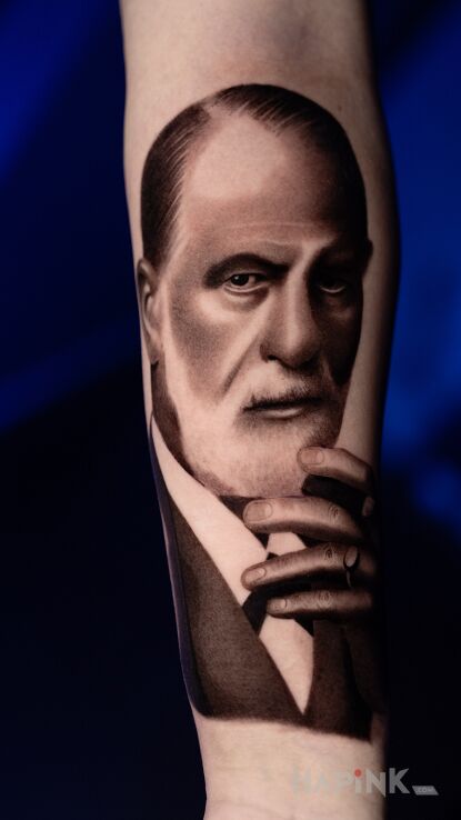 Tattoo Portrait of a man in black and gray motif and realistic style on the forearm