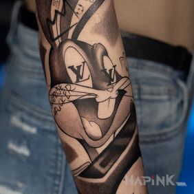 Tattoo Bugs Bunny and LV On the arm motif: characters style: cartoon / comic book