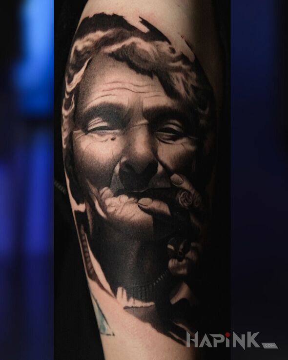 Tattoo Portrait of an elderly woman with a cigar in faces motif and realistic style On the arm