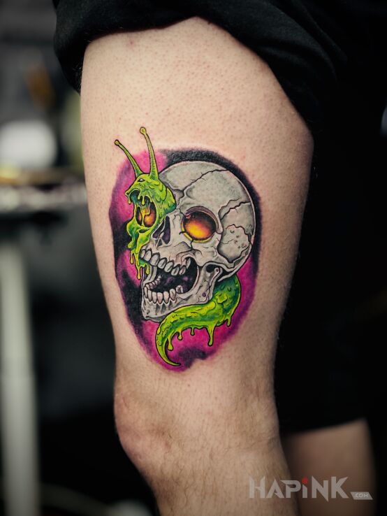 Tattoo Skull with a snail in skulls motif and newschool style on the thigh