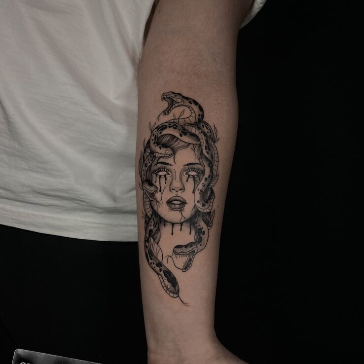 Tattoo Medusa in black and gray motif and graphic / illustrative style on the forearm