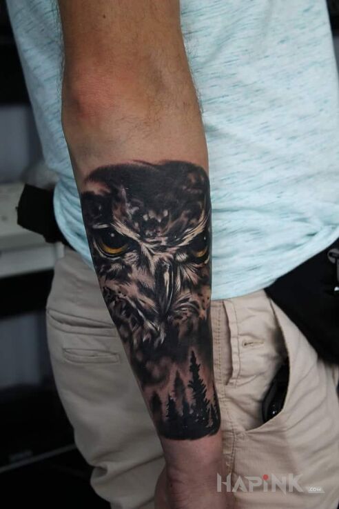 Tattoo Sowa in animals motif on the forearm
