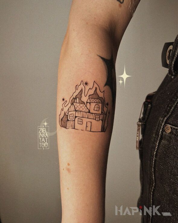 Tattoo Burning Cottage in other motif and ignorant style on the forearm