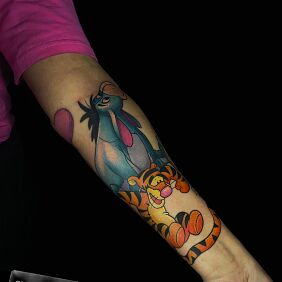 Tattoo Tigger and Eeyore from the Winnie the Pooh cartoon on the forearm motif: colorful style: cartoon / comic book