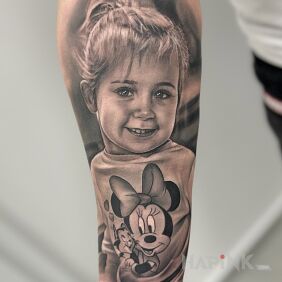 Tattoo Portrait of a girl with Mickey Mouse on the forearm motif: faces style: realistic