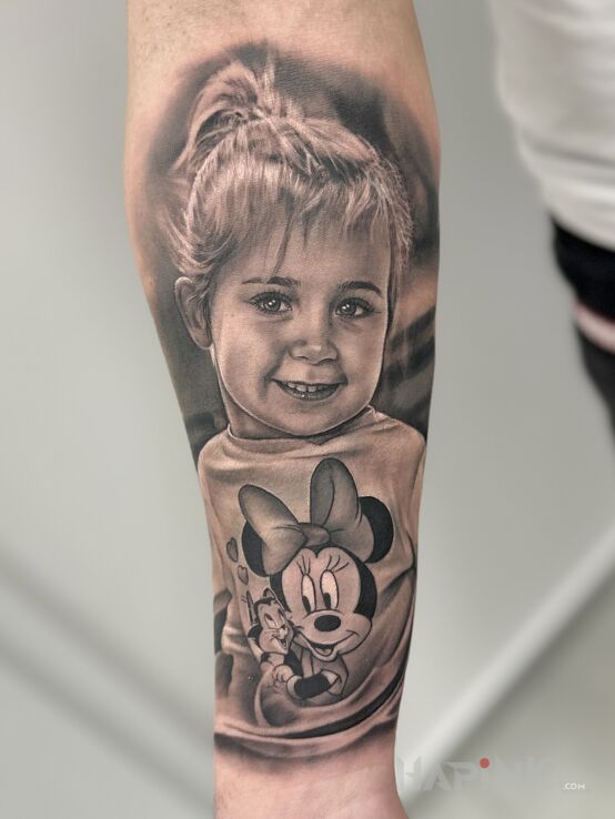 Tattoo Portrait of a girl with Mickey Mouse in faces motif and realistic style on the forearm