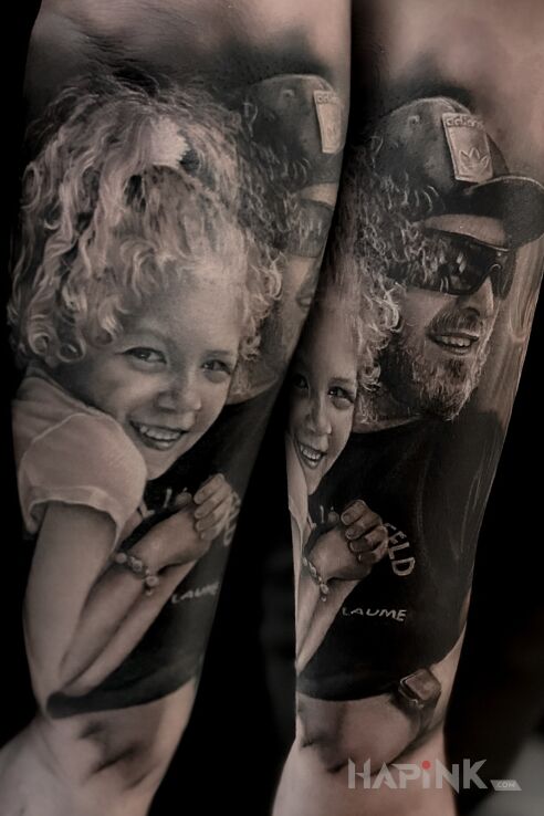 Tattoo Portrait of daughter and dad in faces motif and realistic style on the forearm