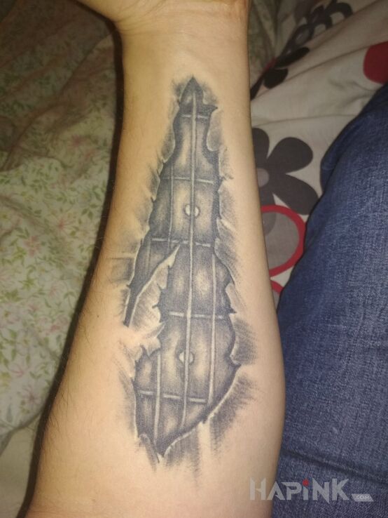 Tattoo Gryf gitary in other motif on the forearm