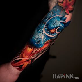 Tattoo Colorful dragon head with maple leaves on the forearm motif: floral style: graphic / illustrative