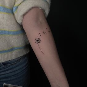 Tattoo Delicate dandelion On the arm motif: black and gray style: minimalistic