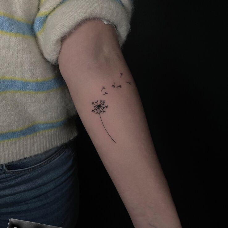 Tattoo Delicate dandelion in minimalistic style On the arm