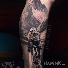 Tattoo Cyclist flying through the mountains on the calf motif: Sport style: realistic