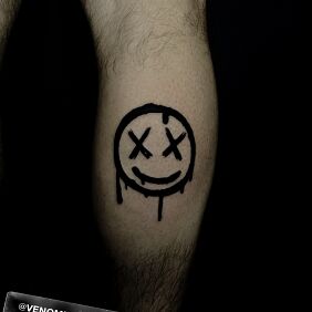 Tatuaż Buźka z iksami na łydce motyw: pozostałe styl: blackwork / blackout