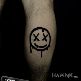 Tattoo Smiley face with X's on the leg motif: other style: blackwork / blackout